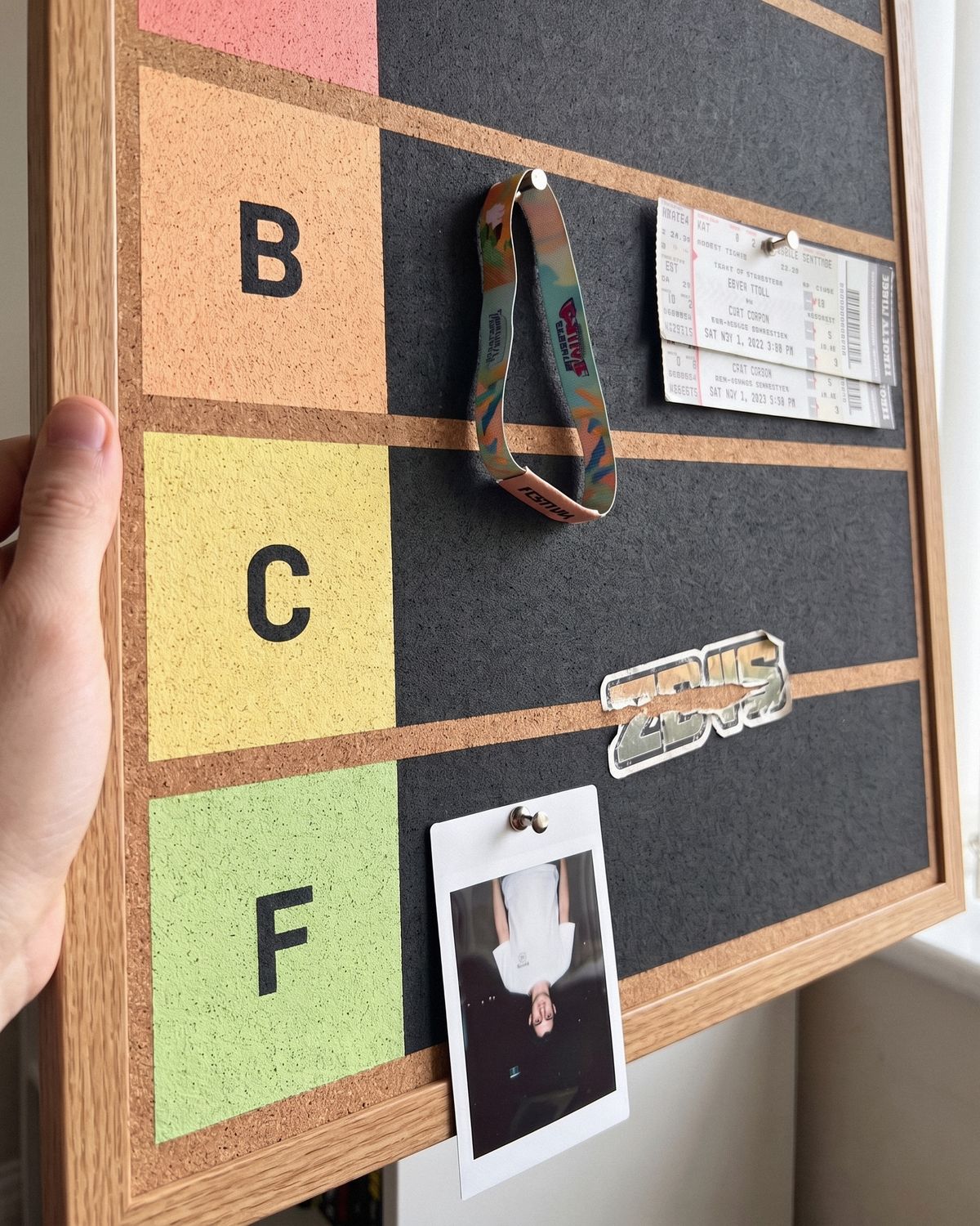 Close up of B, C and F tiers with a demoted polaroid hanging upside down in F