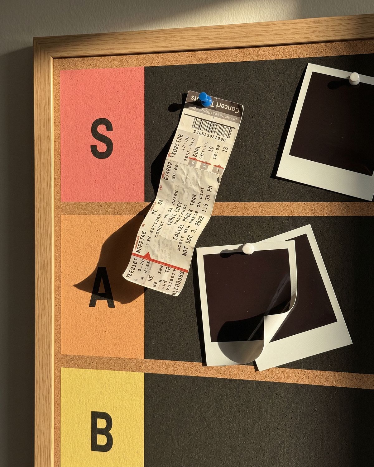 Close up: a concert ticket pinned in S tier hangs down over A tier